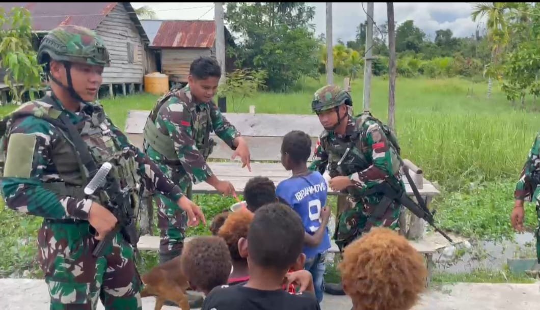 Pos Kamundan Satgas Yonif 642/Kps Bagikan Bubur Kacang Ijo Kepada Anak-Anak di Distrik Kamundan